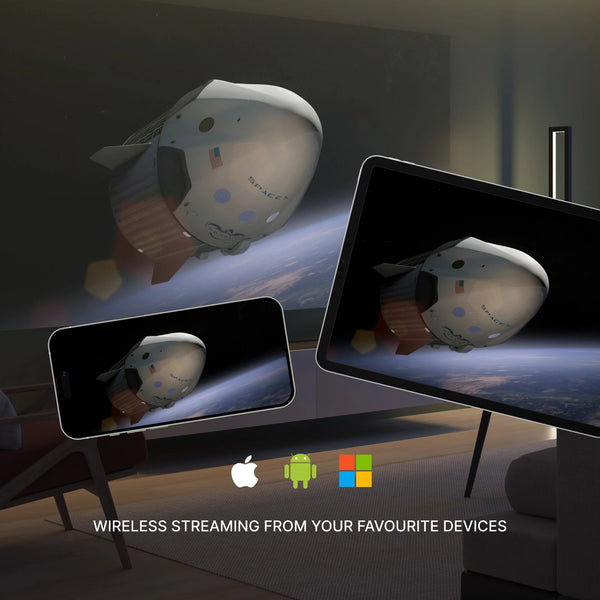 Wireless streaming device displayed on a table with smartphone and tablet showing the same device.